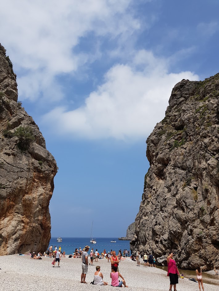 Mallorca Island Tour, Dramatic rock formations framing the sea at the mouth of Torrent de Pareis in Sa Calobra, Mallorca.