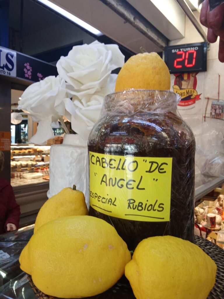 Local honey and traditional products displayed at a Mercat Pere Garau stand.