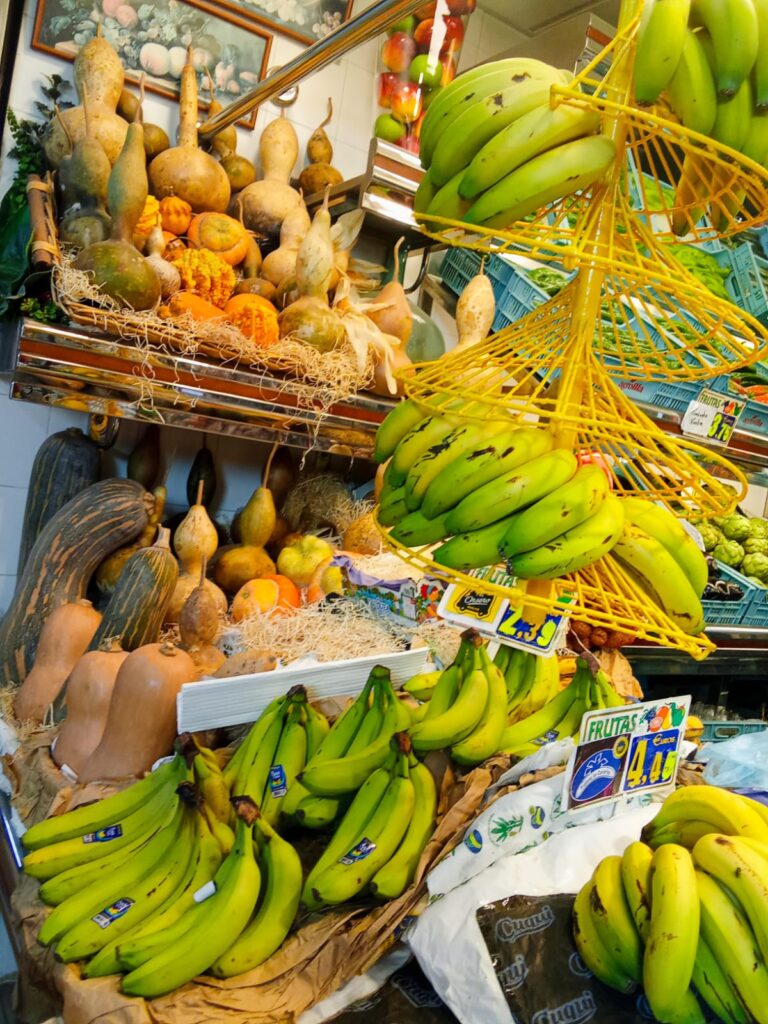 Fresh fruits including bananas and pears beautifully arranged at Mercat Pere Garau.