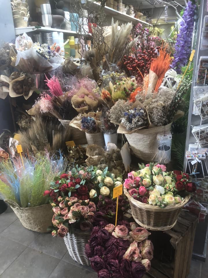 A charming flower stall showcasing beautiful bouquets and dried floral arrangements at Mercat Santa Catalina.