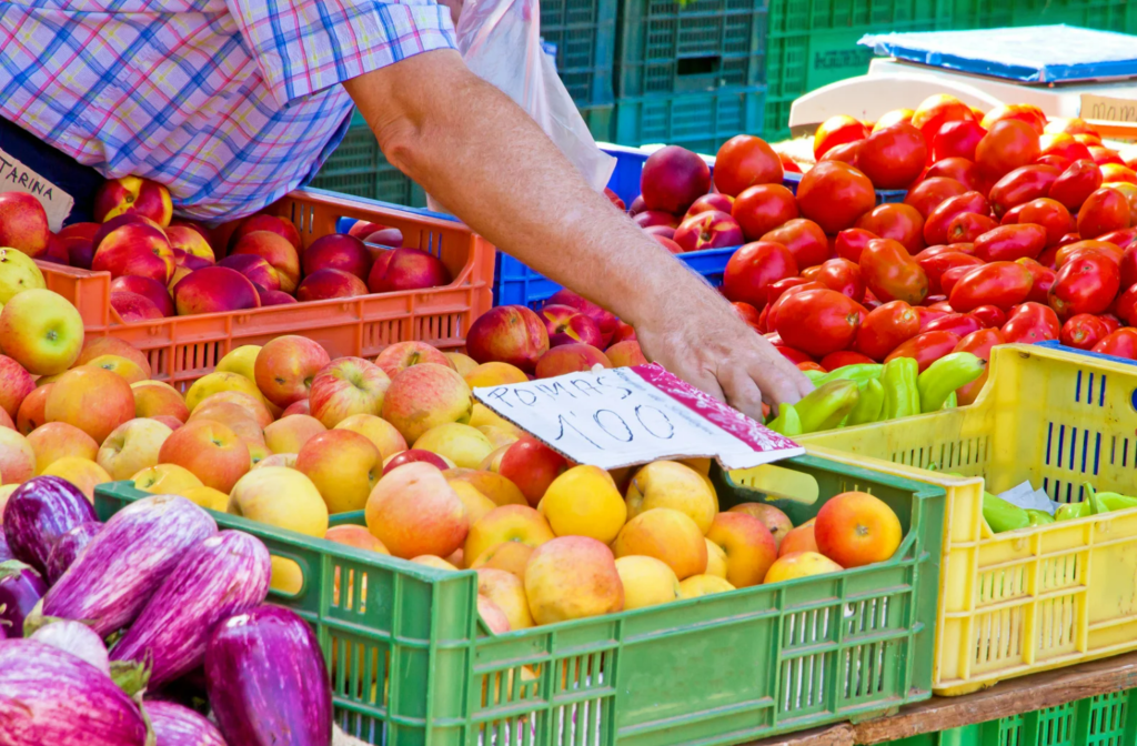 Colorful fruit and vegetable stall at the Cala d'Or weekly market in Mallorca – offering fresh island-grown produce.
