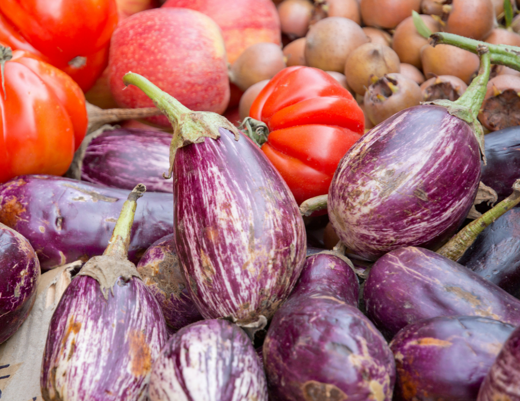 Close-up of fresh eggplants and tomatoes at the weekly market Can Picafort in Mallorca.

