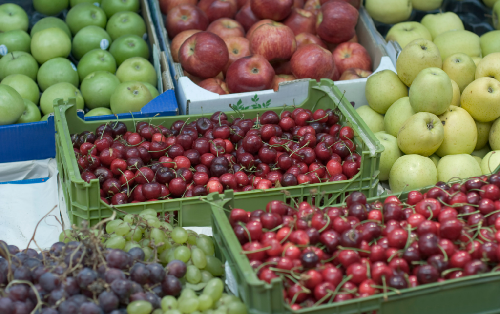 Fresh apples, grapes, cherries, and other local fruits at the Capdepera weekly market in Mallorca.
