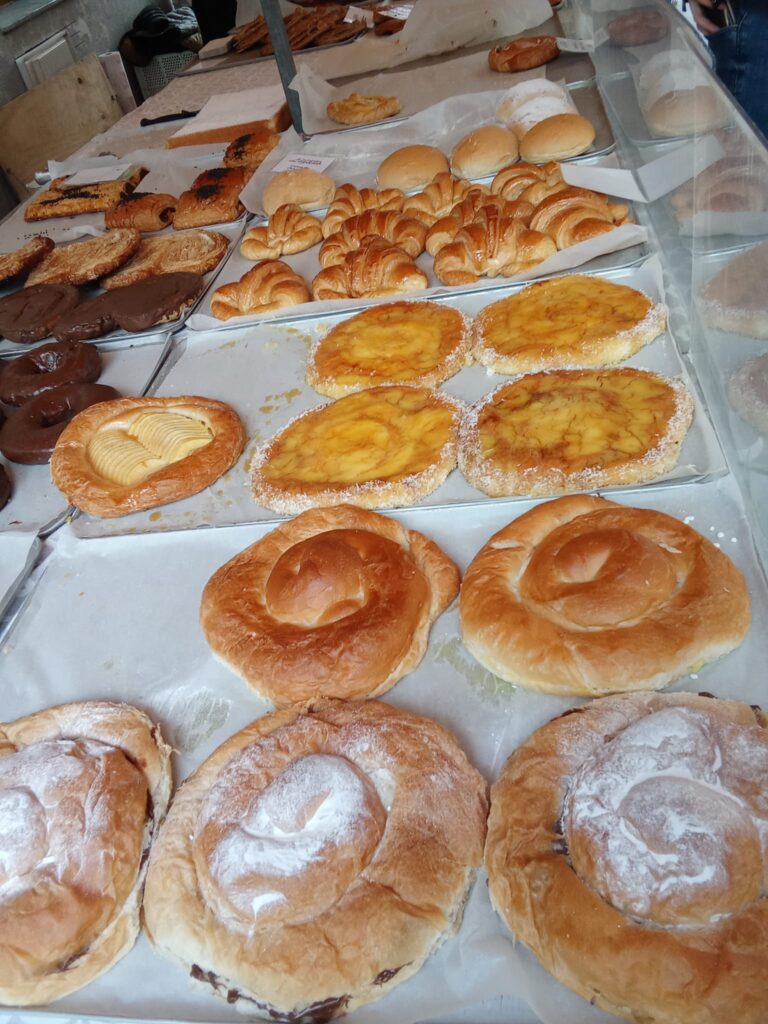Traditional Mallorcan pastries including ensaïmadas and cocas at the weekly market Capdepera.