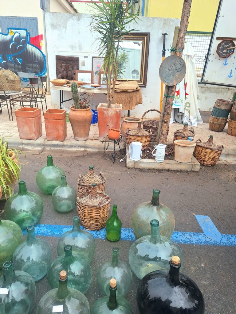 Vintage demijohn bottles and antique market finds at the weekly market Consell, Mallorca – a paradise for collectors and history lovers.