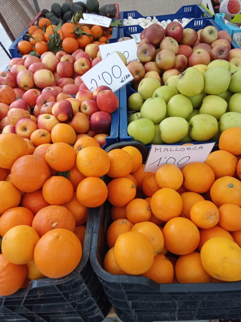 Fresh apples, oranges, and citrus fruits from Mallorca on display at the Weekly Market Paguera, sold by the kilo from local farmers.