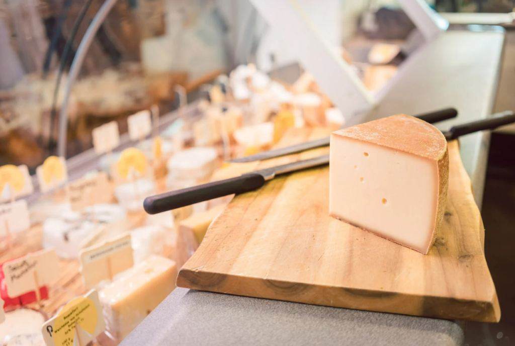 Artisanal cheese on display at the weekly market in Port d'Alcúdia, Mallorca – featuring local delicacies from Balearic producers