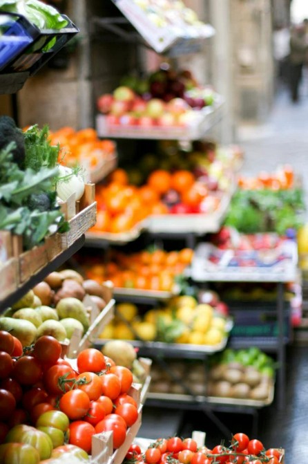 Colorful display of fruits and vegetables at the weekly market in Sant Elm Mallorca, showcasing local Mediterranean freshness.