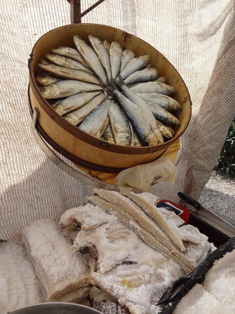 Freshly caught and salt-preserved fish, including sardines and cod, displayed at a seafood stall at the Weekly Market in Santa Ponsa, Mallorca.