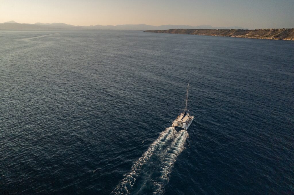Aerial view of a Life & Sea catamaran sailing through the open waters of Mallorca at sunset – peaceful, scenic, and unforgettable.