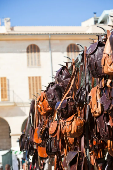 Leather bags and backpacks at the market in Inca on Mallorca.